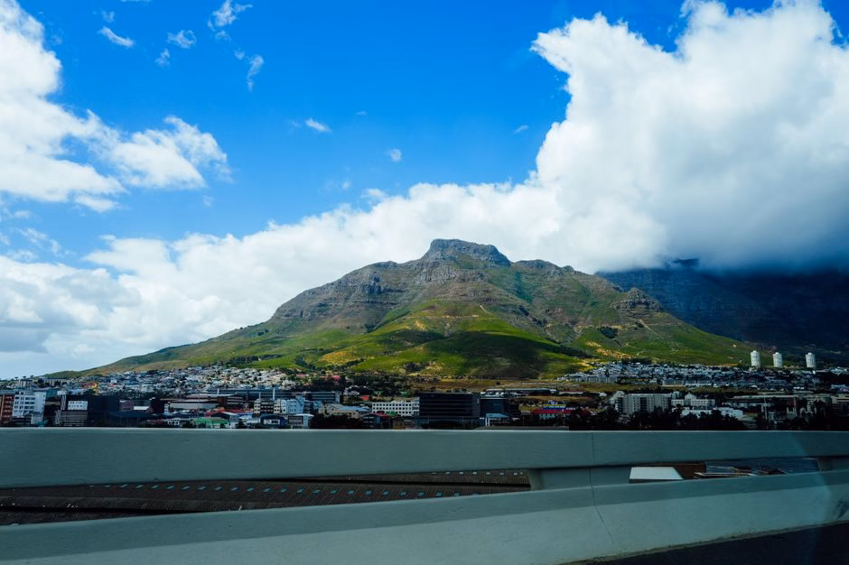 Stunning landscape of Cape Town's iconic Table Mountain under a bright blue sky.