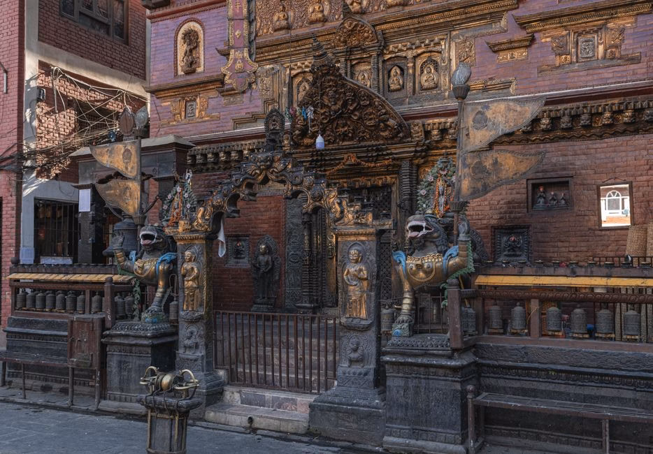 Intricate temple facade in Kathmandu, showcasing ornate carvings and statues.